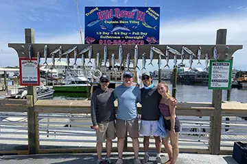 Family smiling with Spanish Mackerel catch on Half Day fishing trip from Carolina Beach